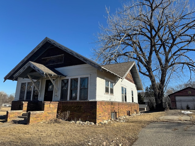 view of front facade with a garage and an outdoor structure