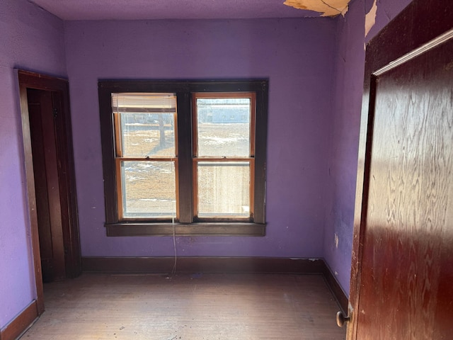 unfurnished room with hardwood / wood-style floors