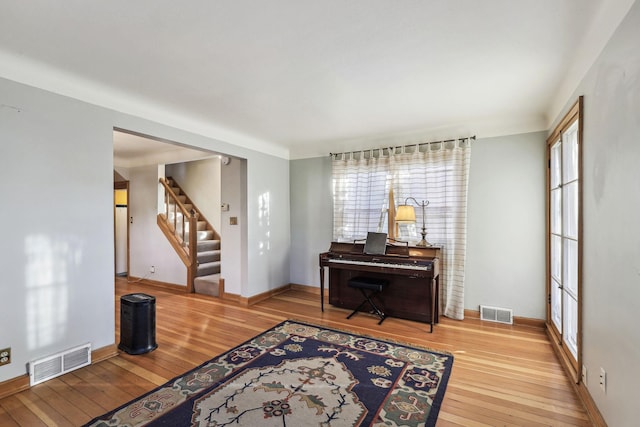 sitting room with a healthy amount of sunlight and hardwood / wood-style floors