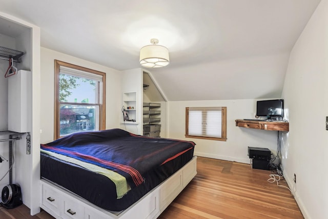 bedroom with light hardwood / wood-style flooring and vaulted ceiling