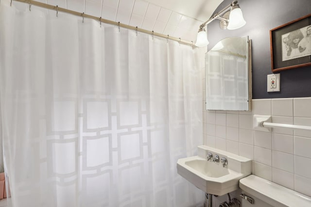 bathroom with tile walls, sink, tasteful backsplash, and toilet