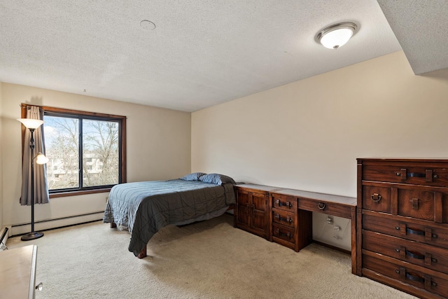 carpeted bedroom with a baseboard heating unit and a textured ceiling