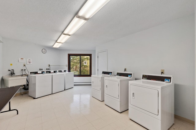 clothes washing area featuring sink, a textured ceiling, and independent washer and dryer