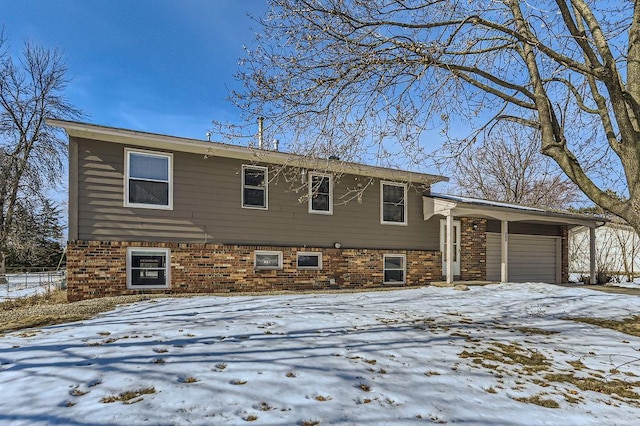 split level home featuring brick siding and an attached garage