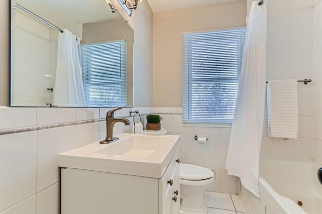 bathroom featuring toilet, tile walls, tile patterned floors, and a wealth of natural light