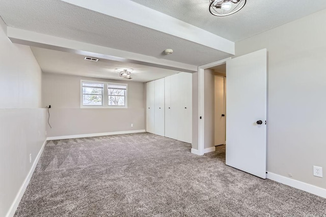 interior space with visible vents, baseboards, a textured ceiling, and carpet flooring