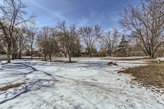 snowy yard with a tennis court