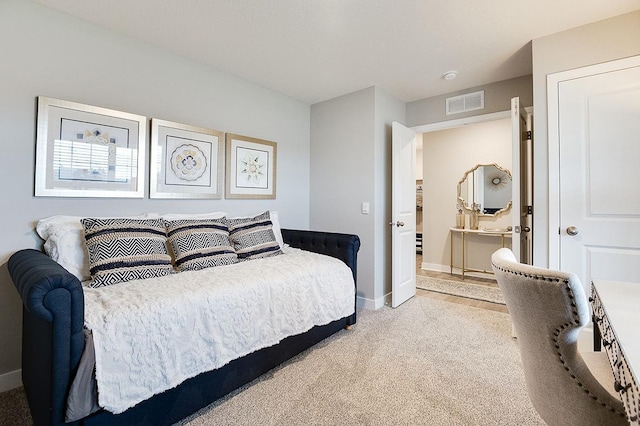 bedroom featuring light carpet