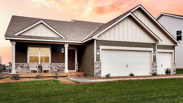 craftsman-style home with a yard, a garage, and a porch