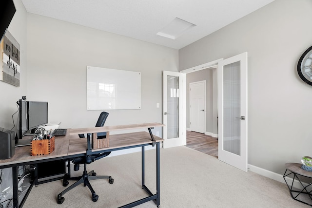 carpeted office featuring french doors and baseboards