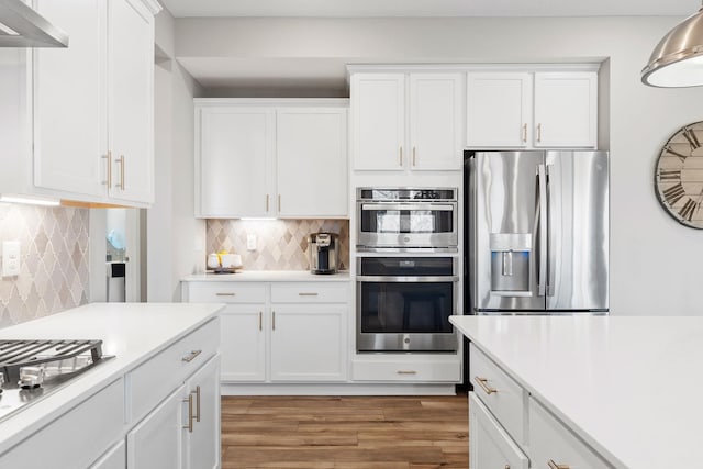 kitchen featuring white cabinetry, stainless steel appliances, and light countertops