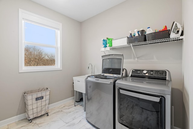 laundry area featuring laundry area, separate washer and dryer, marble finish floor, and baseboards