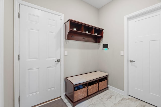 mudroom featuring marble finish floor and baseboards