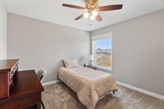 carpeted bedroom featuring ceiling fan and baseboards