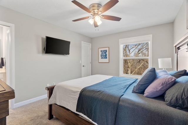 bedroom featuring light colored carpet, a ceiling fan, and baseboards