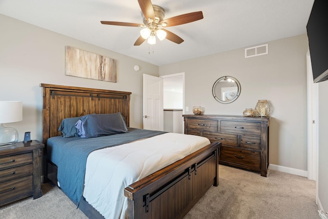 bedroom featuring a ceiling fan, baseboards, visible vents, and light carpet