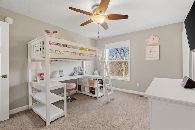 carpeted bedroom with a ceiling fan and baseboards