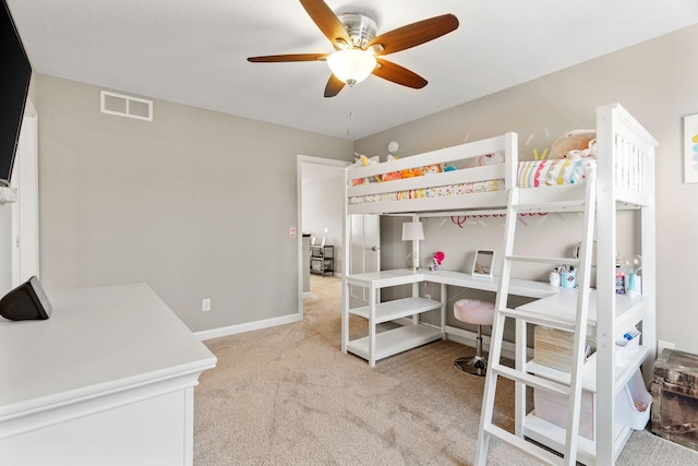 bedroom with visible vents, baseboards, light colored carpet, and ceiling fan