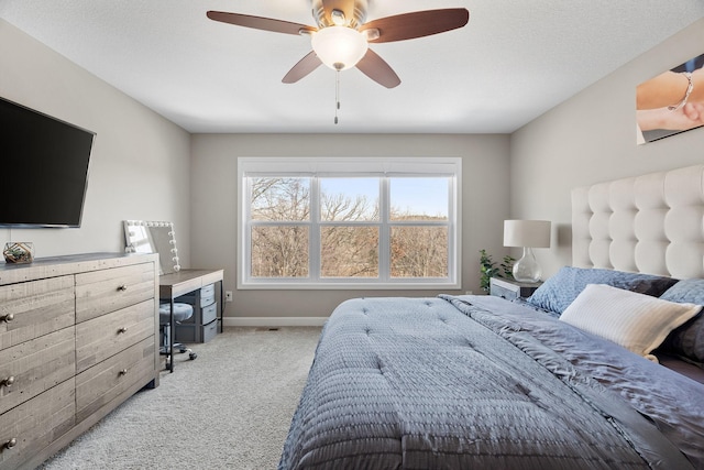 carpeted bedroom with a ceiling fan and baseboards