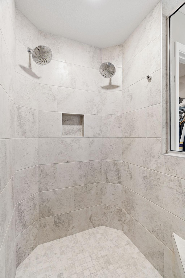 full bathroom with tiled shower