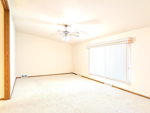 empty room featuring ceiling fan and carpet