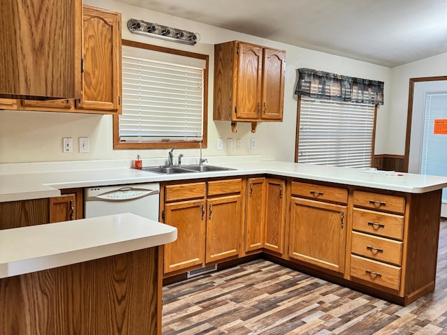 501 Lac Qui Parle Ave N, Canby, MN 56220 - kitchen with a peninsula, white dishwasher, wood finished floors, and a sink