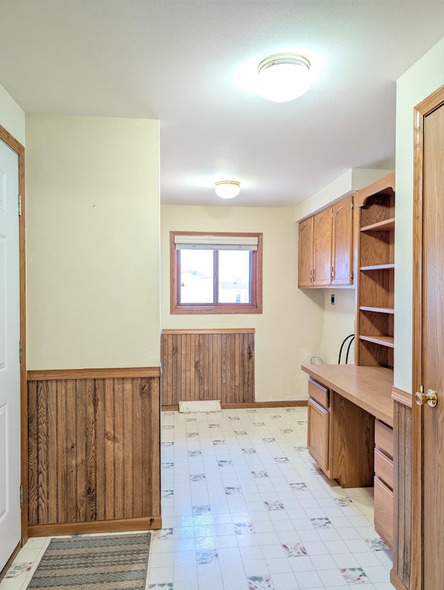 501 Lac Qui Parle Ave N, Canby, MN 56220 - kitchen featuring open shelves, light countertops, wainscoting, light floors, and wooden walls