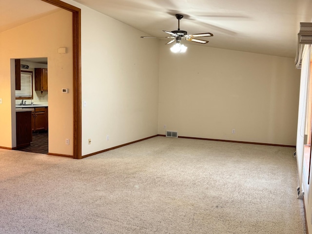 501 Lac Qui Parle Ave N, Canby, MN 56220 - carpeted spare room with a ceiling fan, a sink, vaulted ceiling, and baseboards