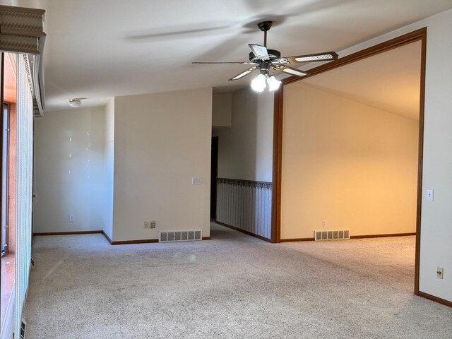 501 Lac Qui Parle Ave N, Canby, MN 56220 - spare room featuring ceiling fan, carpet flooring, vaulted ceiling, and baseboards