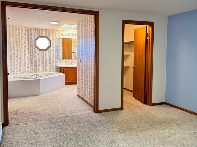501 Lac Qui Parle Ave N, Canby, MN 56220 - bathroom with wallpapered walls, baseboards, carpet, and a garden tub