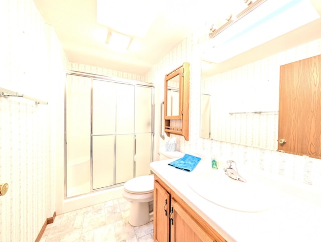 501 Lac Qui Parle Ave N, Canby, MN 56220 - bathroom featuring a shower stall, wallpapered walls, vanity, and toilet