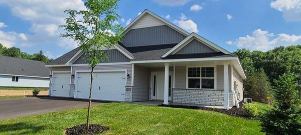 view of front of home featuring a garage, a front yard, and covered porch