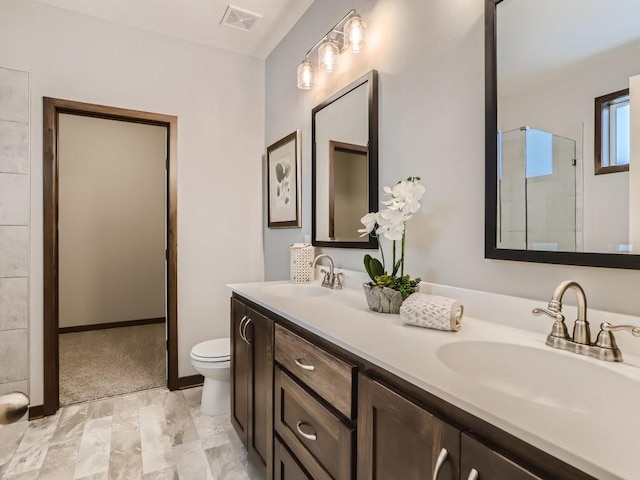 bathroom with vanity, walk in shower, and toilet