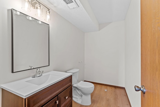 10 94th Cir NW Unit 201, Coon Rapids, MN 55448 - half bathroom featuring wood finished floors, toilet, vanity, and baseboards
