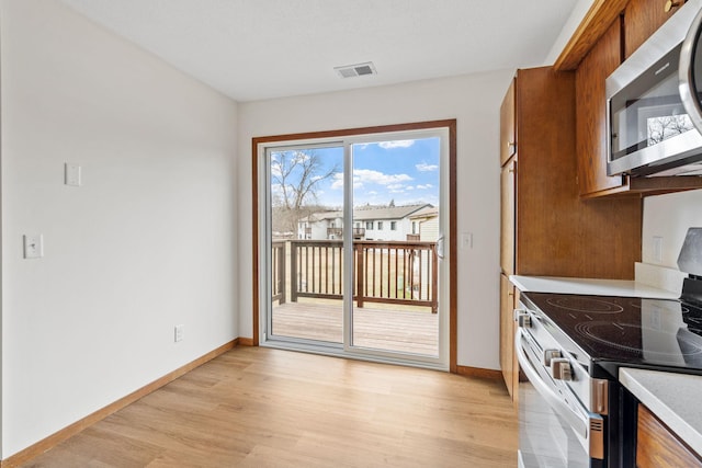 10 94th Cir NW Unit 201, Coon Rapids, MN 55448 - unfurnished dining area featuring light wood-type flooring and baseboards