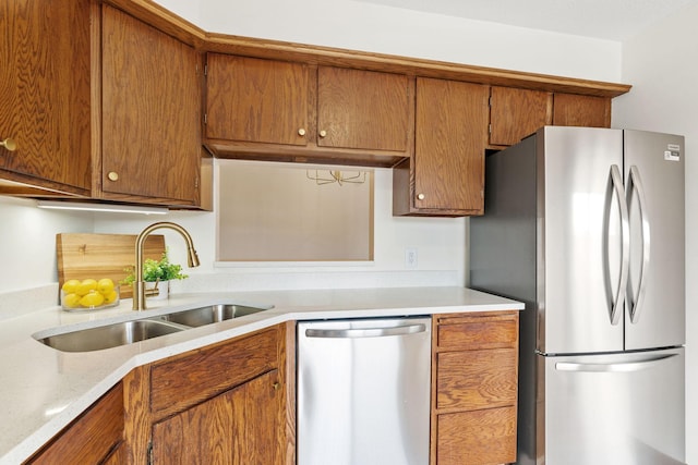 10 94th Cir NW Unit 201, Coon Rapids, MN 55448 - kitchen with stainless steel appliances, a sink, light countertops, and brown cabinetry