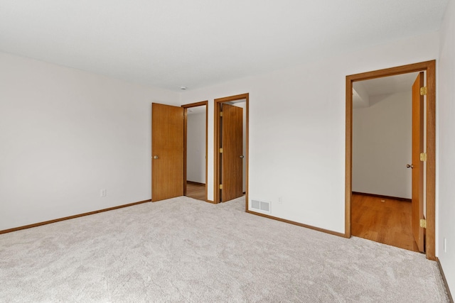 10 94th Cir NW Unit 201, Coon Rapids, MN 55448 - unfurnished bedroom featuring carpet floors and baseboards