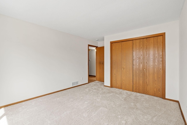 10 94th Cir NW Unit 201, Coon Rapids, MN 55448 - unfurnished bedroom with carpet, a closet, and baseboards