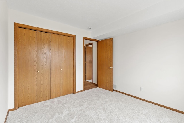 10 94th Cir NW Unit 201, Coon Rapids, MN 55448 - unfurnished bedroom with a closet, carpet floors, and baseboards