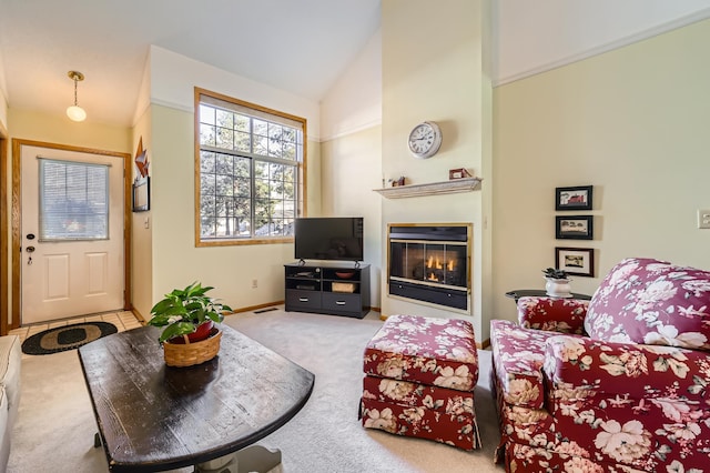 carpeted living room featuring vaulted ceiling