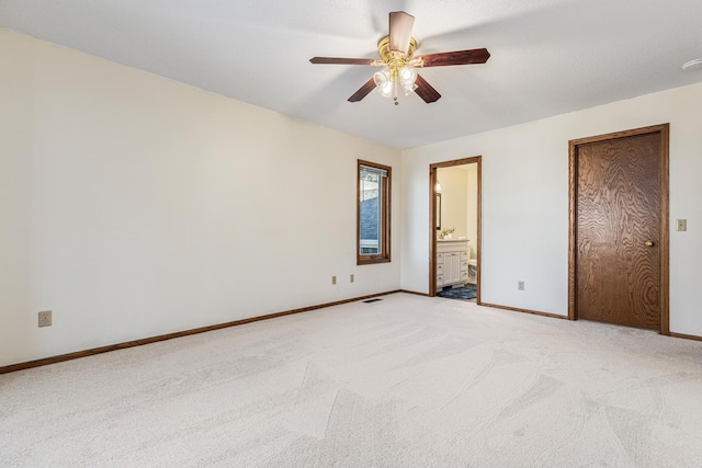 unfurnished bedroom featuring ceiling fan, connected bathroom, and light carpet