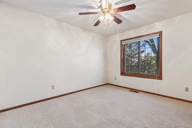 unfurnished room with carpet floors, a textured ceiling, and ceiling fan