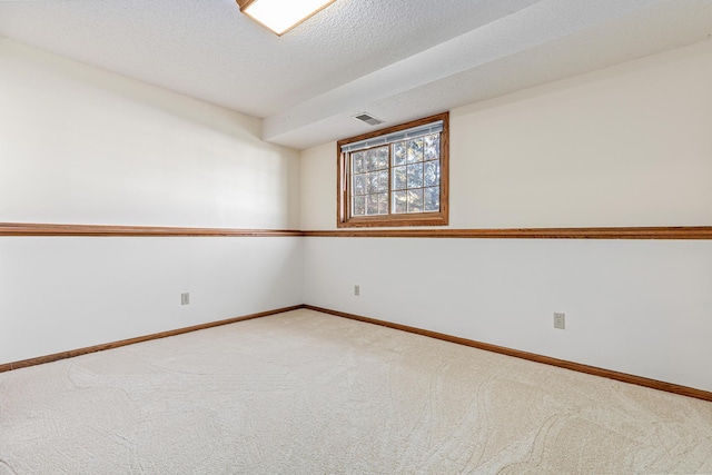 carpeted spare room featuring a textured ceiling