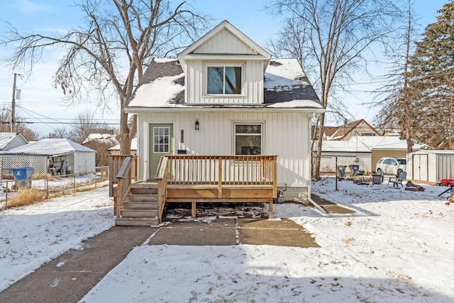 bungalow-style house with a wooden deck and a shed