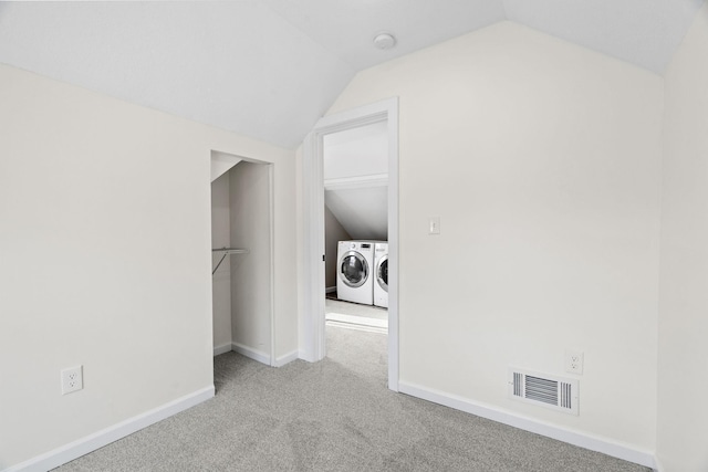 interior space with washing machine and dryer and lofted ceiling