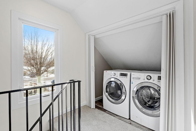 laundry area featuring separate washer and dryer and hardwood / wood-style floors