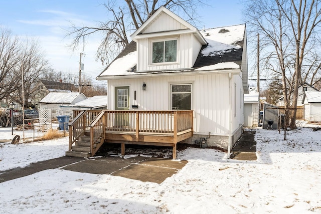 snow covered property featuring a wooden deck