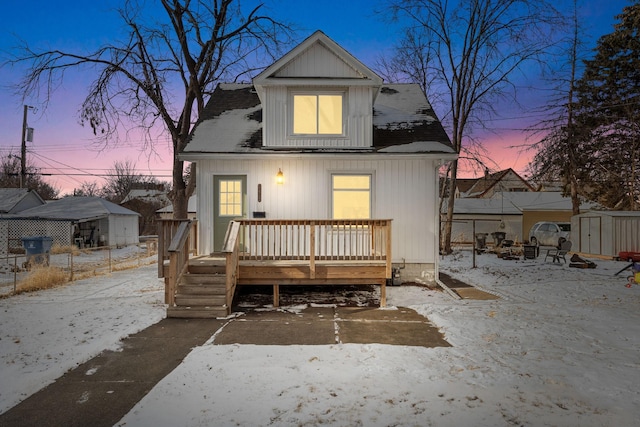 bungalow-style home with a deck and a shed