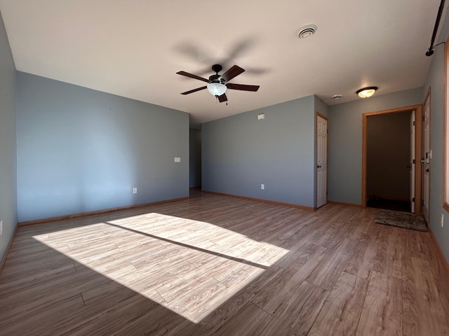 empty room featuring ceiling fan and light wood-type flooring