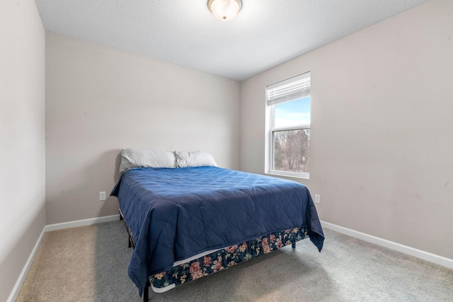 bedroom featuring a textured ceiling and carpet